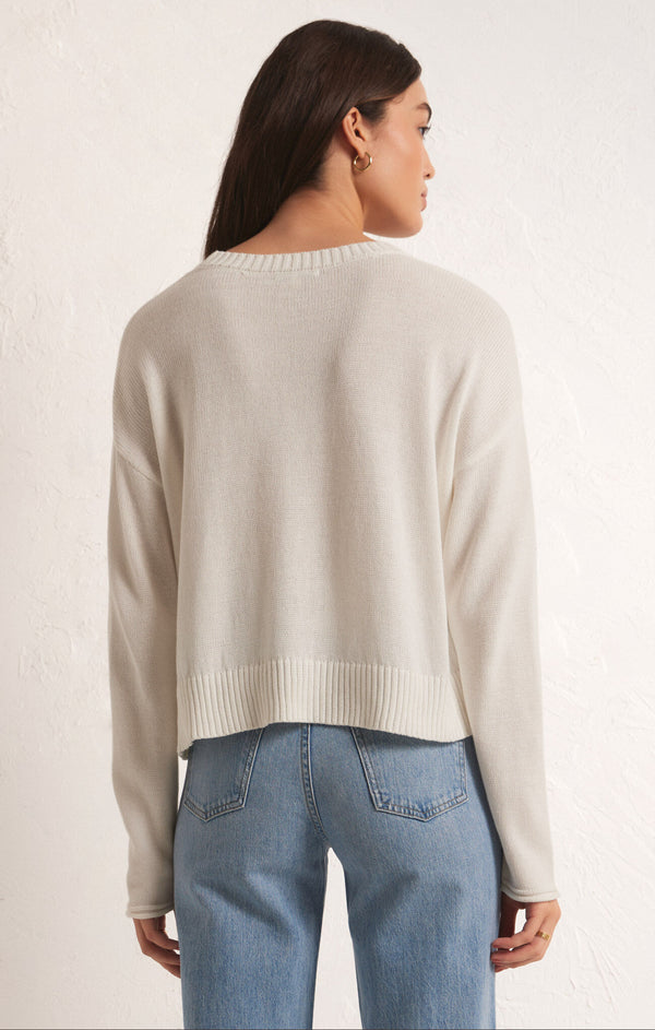 back view of the model wearing the sienna vacay sweater. shows the ribbed detail on the neckline and the bottom hem. also shows the crew neckline and the dropped shoulders. 
