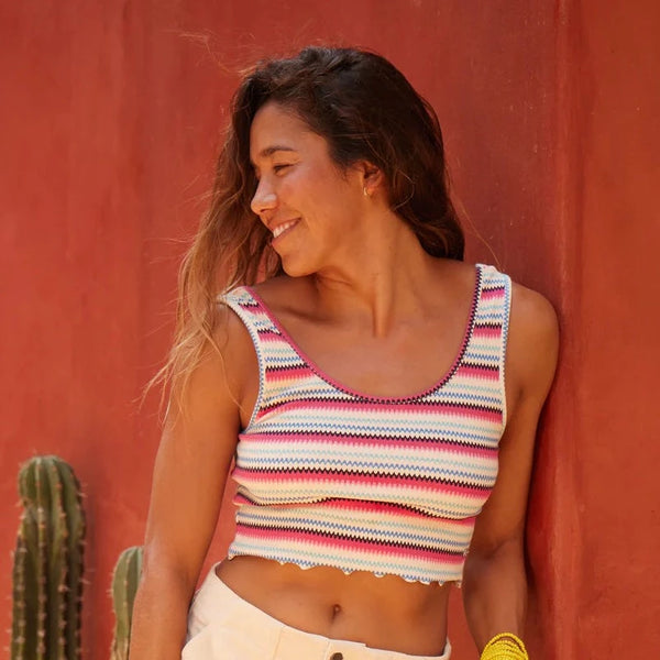 front view of the model wearing the keep it wavy printed ribbed tank top. shows the scoop neckline. also shows the lettuce bottom trim, the cropped length, and the tank straps. 