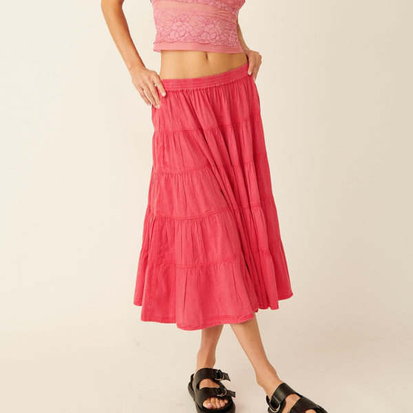 front view of the model wearing the in full swing midi skirt. shows the low waist. also shows the a line hem, the midi length and the stretchy elastic waistband. 