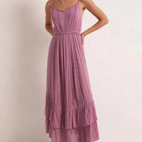 front view of the model wearing the rose maxi dress. shows the v neckline. also shows the elastic waistband, the bottom tiered ruffles and the adjustable straps. 