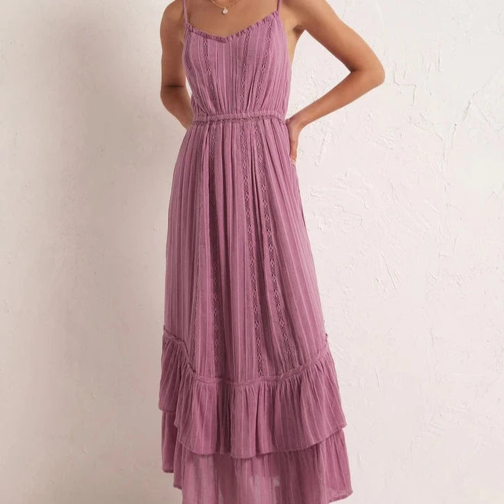 front view of the model wearing the rose maxi dress. shows the v neckline. also shows the elastic waistband, the bottom tiered ruffles and the adjustable straps. 
