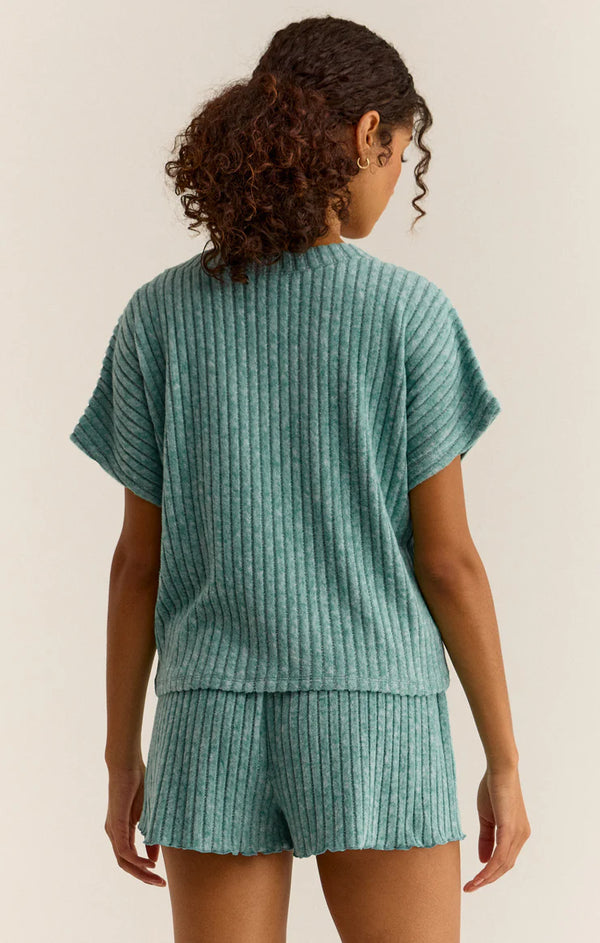 back view of the model wearing the harper rib v neck top. shows the dolman sleeve. also shows the ribbed detailing thoughout. 
