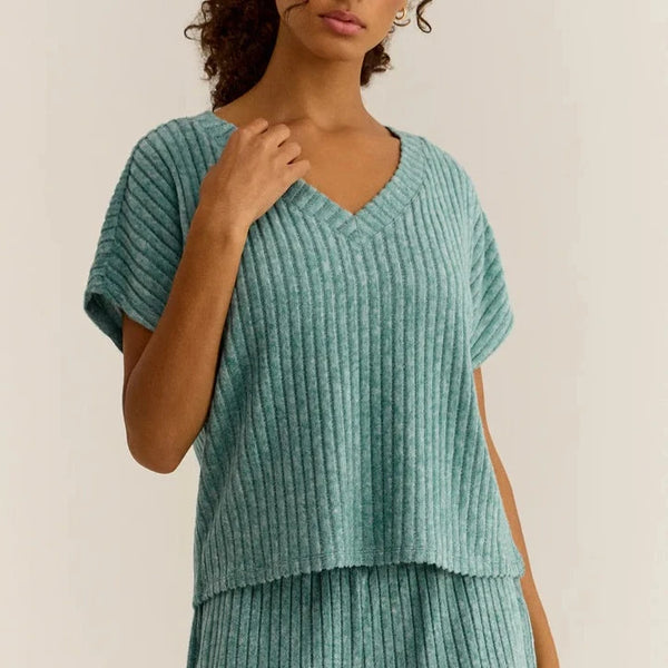 front view of the model wearing the harper rib v neck top. shows the v neckline. also shows the dolman sleeves and the ribbed detailing throughout. 