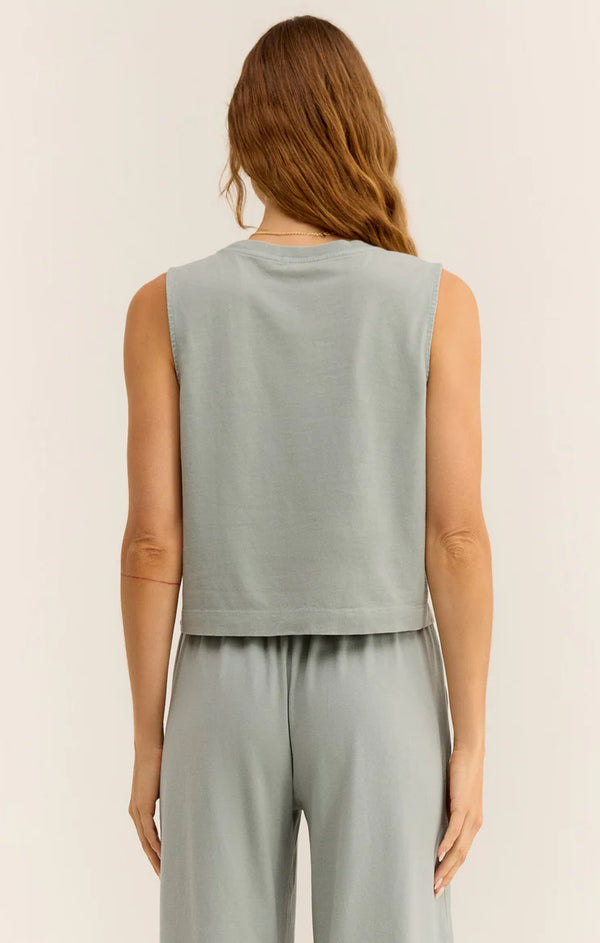 back view of the model wearing the sloane jersey muscle tank. shows the muscle tank silhouette. also shows the crew neckline and the relaxed fit.  
