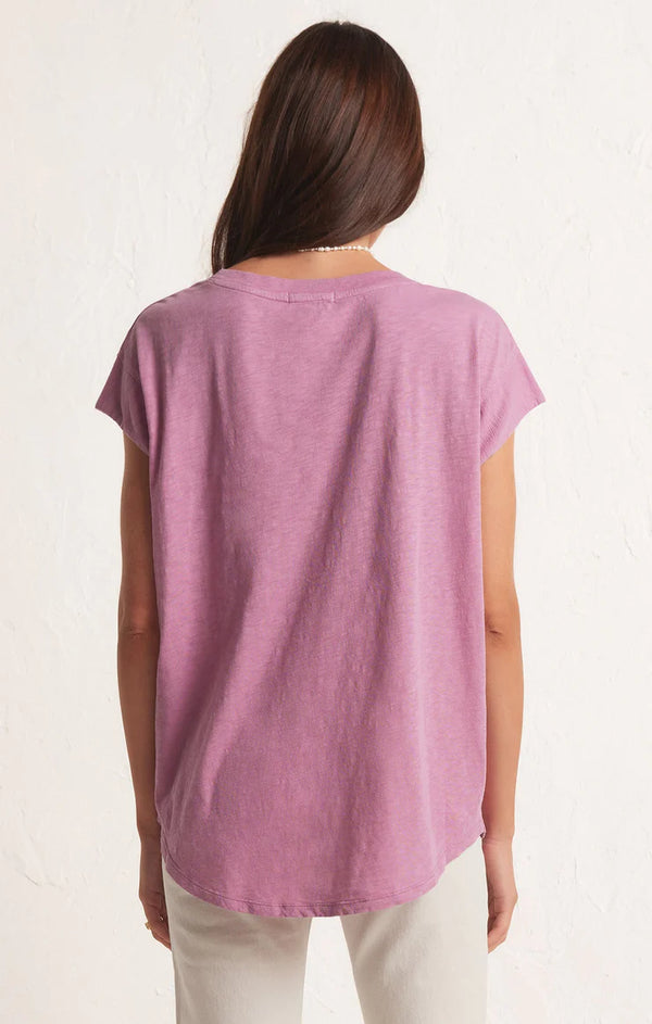 back view of the model wearing laid back slub top in dusty orchid. shows the oversized fit. also shows the scooped bottom hem. 