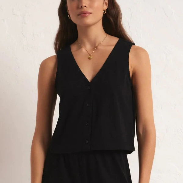 front view of the modelw earing the solace textured slub top in black. shows the front button closure. also shows the deep v neck and relaxed fit. 