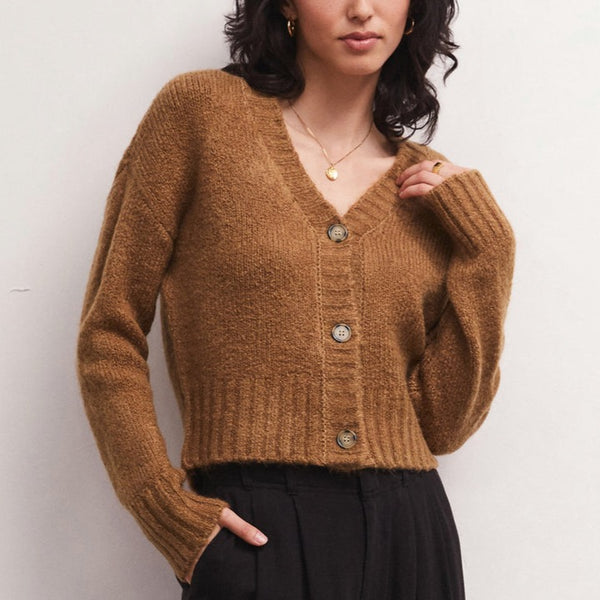 front view of the Allegra cardigan in camel. shows the v neckline. also shows the front button closure, the drop shoulders, and the ribbed detailing on the cuffs, hem and neckline.