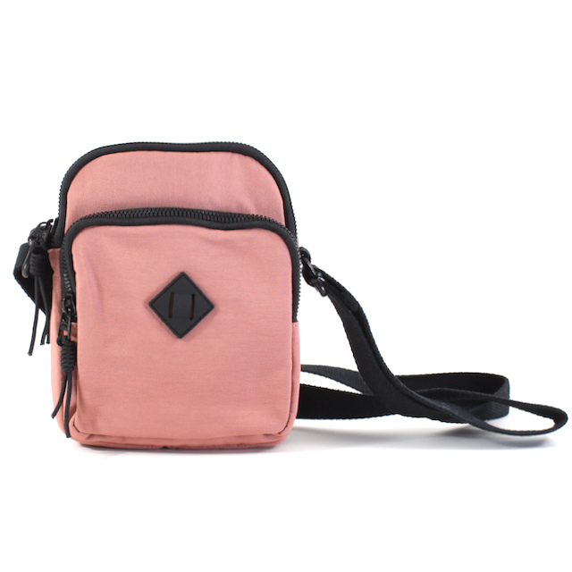 front view of the jamie nylon crossbody in pink. shows the black adjustable crossbody strap, the three zipper closure compartments and the black diamond detail on the front. 