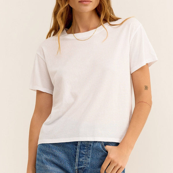 front view of the model wearing the go to tee. shows the crew neckline. also shows the relaxed fit, shows that the top is cropped and the short sleeves. 