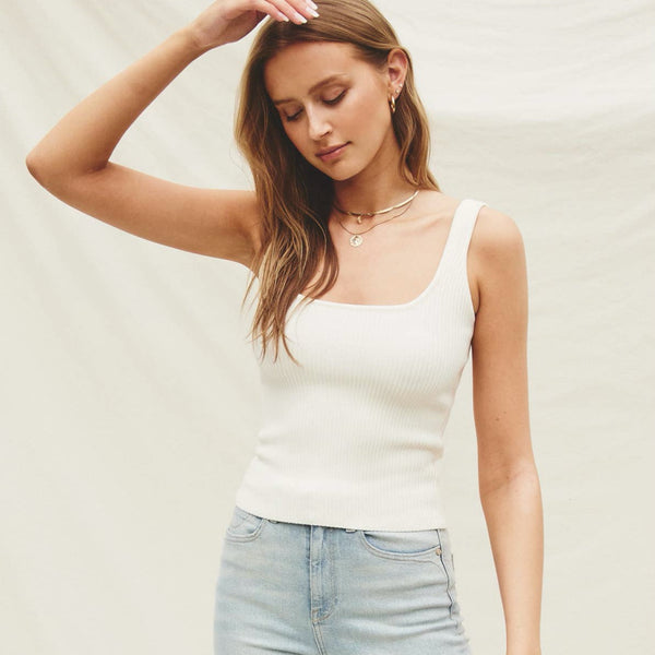 Front view of model wearing tank. Shows the square neckline. Also shows the ribbed ottoman stitch, the tank style, the waist length and the beautiful ivory color. 