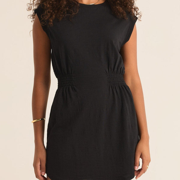 front view of the model wearing the rowan textured knit dress. shows the muscle style sleeves. also shows the cinched waist and the scoop neckline. 