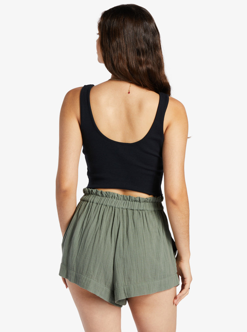 back view of model in the black tank. shows the low scoop back and lettuce edge hemline.