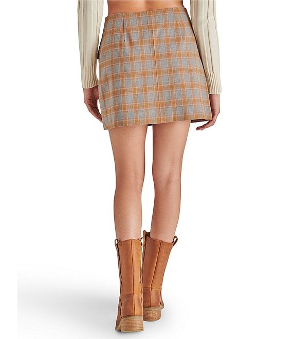 back view of model in skirt. shows them mini length and plaid detail.