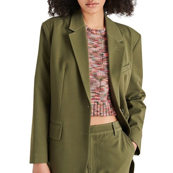 front view of model in blazer. shows the lapel collar neckline, long sleeves and front pockets.