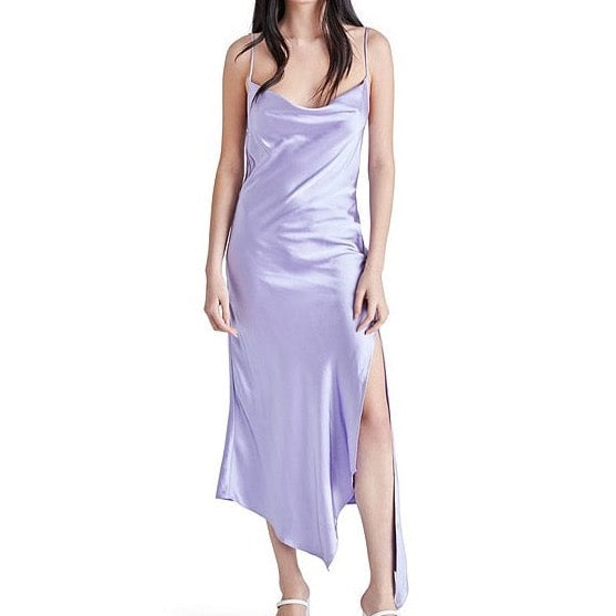 front view of model wearing dress. shows the cowl neckline, side slit, asymmetrical hemline and spaghetti straps.