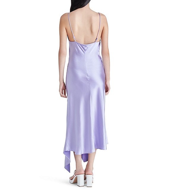 shows a back view of model in the dress. shows the adjustable spaghetti straps, and asymmetrical hemline.