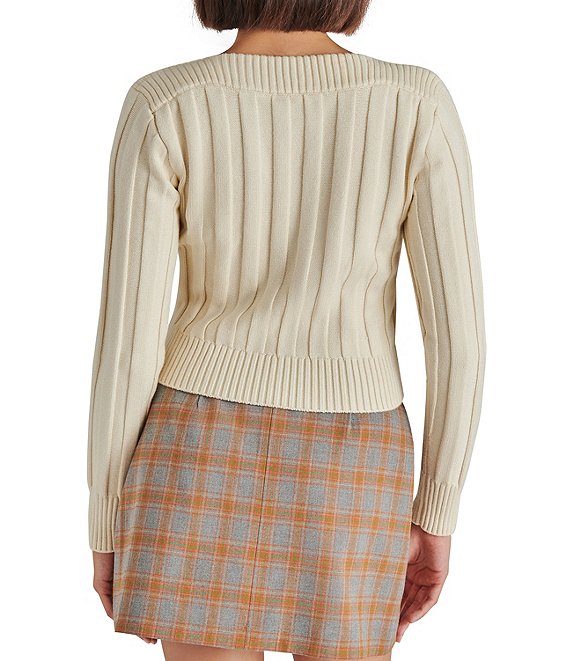 back view of model in sweater. shows cropped length ribbed fabrication and boat neck.