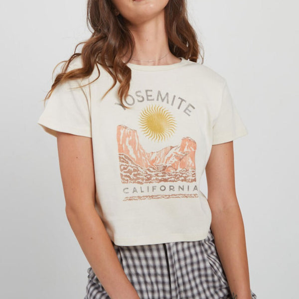 front view of the yosemite sun baby tee. shows the short sleeves. also shows the crew neckline and the front graphic that says yosemite california with mountains and the sun, 