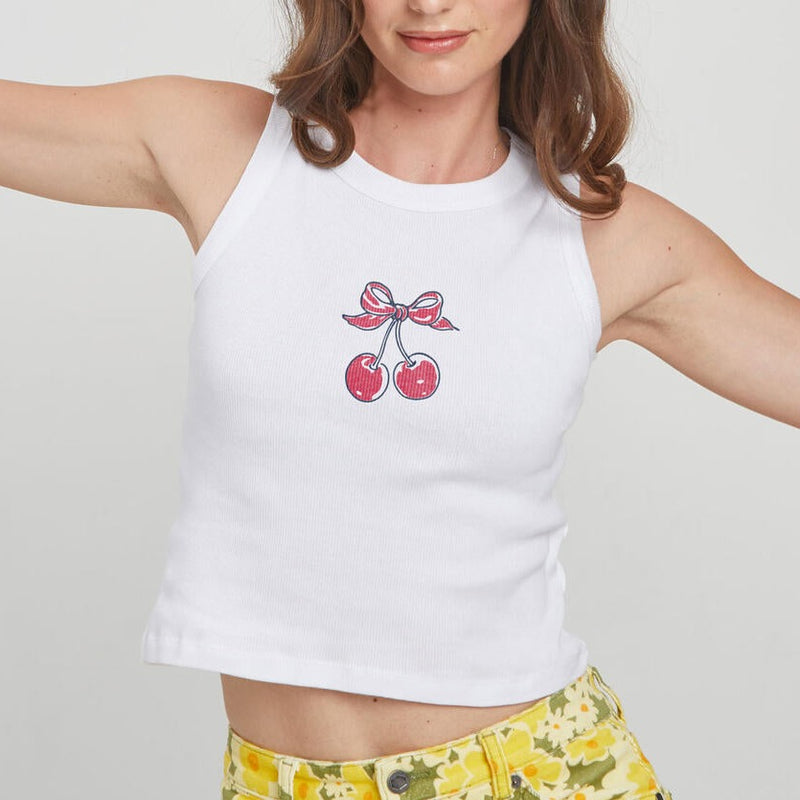 front view of the model wearing the cherry bow tank. shows the ribbed detailing. also shows the high neckline and the front cherry/bow graphic. 