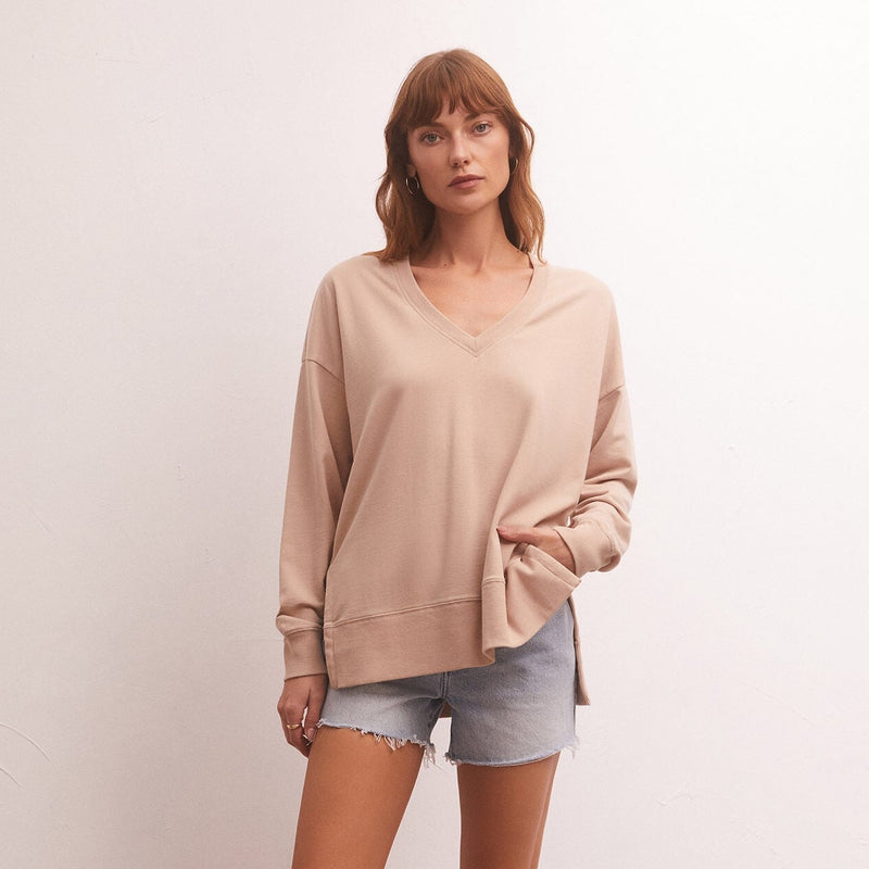 front view of model in shirt. shows relaxed fit, v-neckline and dropped shoulders 
