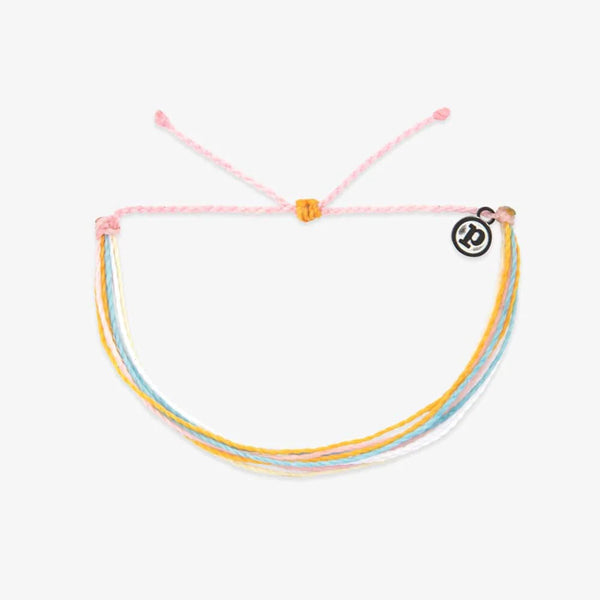 Multicolored bracelet with a pink string on a white background