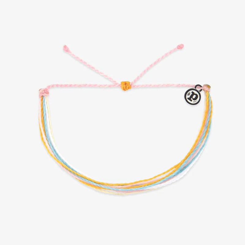 Multicolored bracelet with a pink string on a white background