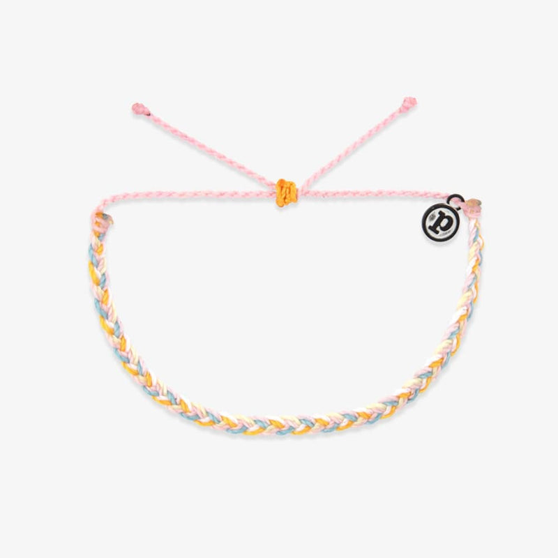Braided bracelet with a pink string on a white background