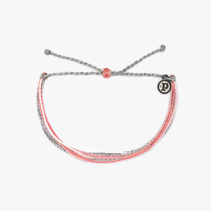 front view of the yours to keep bracelet. shows the pull closure. also shows the pura vida charm and the different colors of grey, pink and cream.