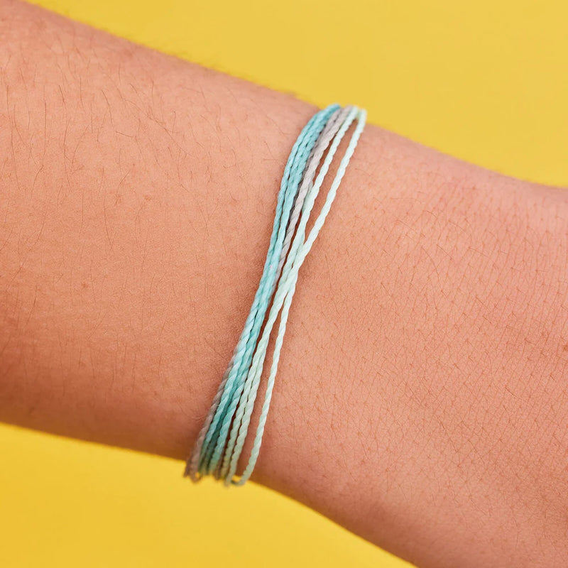 Shows multi string bracelet on models wrist.