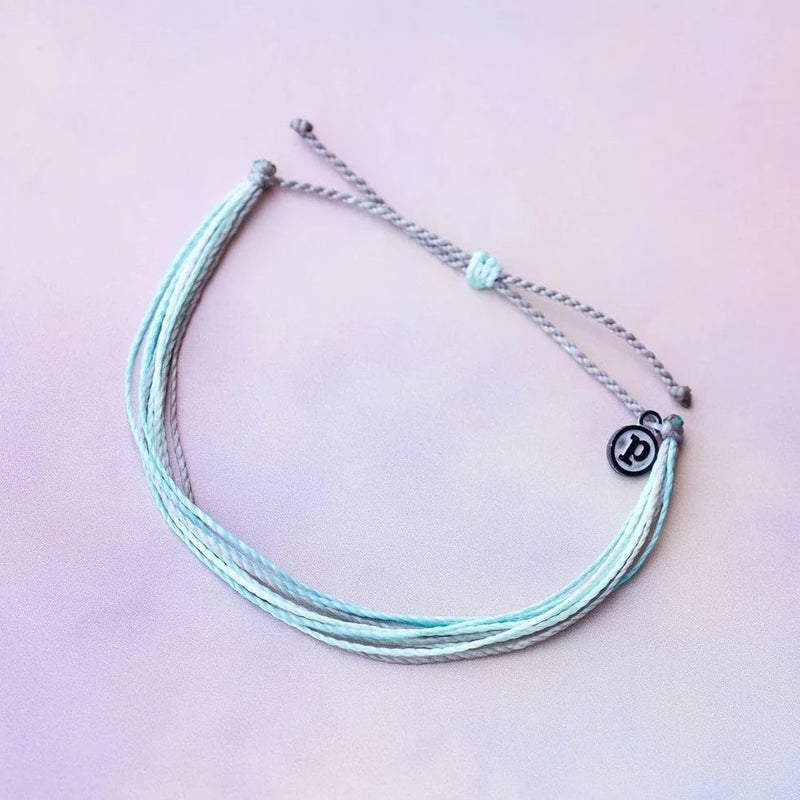 Shades of blue wax coated multi string bracelet with adjustable ties.