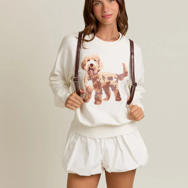 front view of the puppy long sleeve sweater. shows the front puppy graphic. also shows the crew neckline, the dropped shoulders, the tighter band and the white color. 