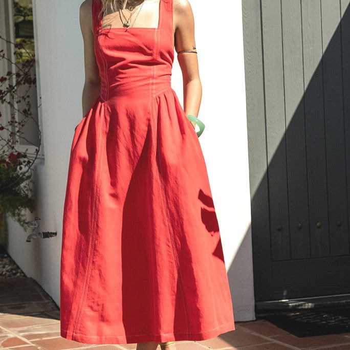 front view of the amelia dress. shows the square neckline, also shows the wider strap the contrast stitching detailing, the midi length and the fit and flare style. 