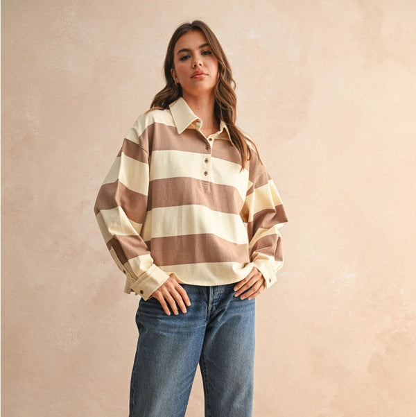 front view of the emma long sleeve top. shows the ivory and mocha color. also shows the collared neckline, the Henley style with button closure on the neckline. 