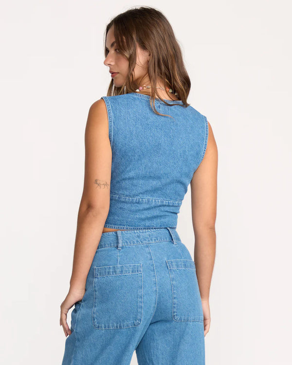 Woman wearing a blue denim outfit on a white background