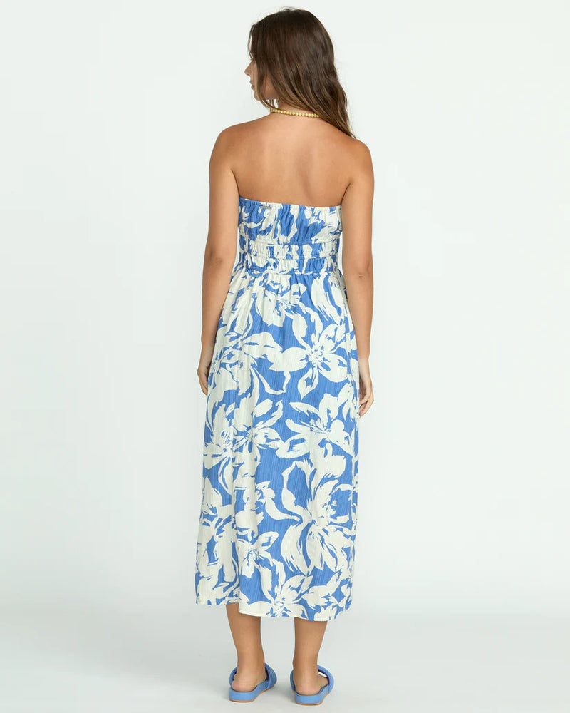 back view of the model wearing the in the sky midi dress. shows the midi length, the strapless top and the elastic waist. 