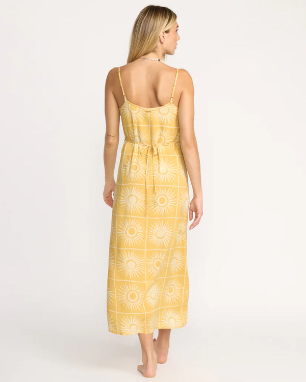 Woman wearing a yellow patterned dress on a white background