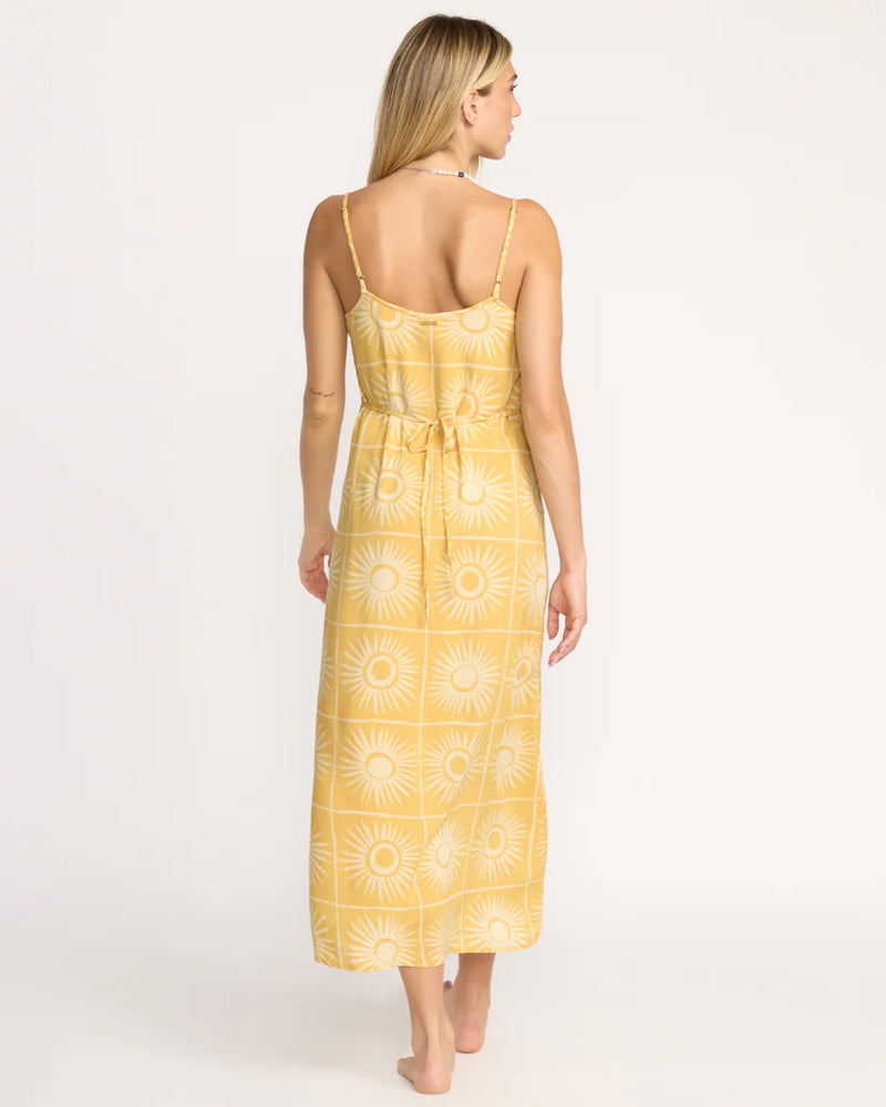 Woman wearing a yellow patterned dress on a white background