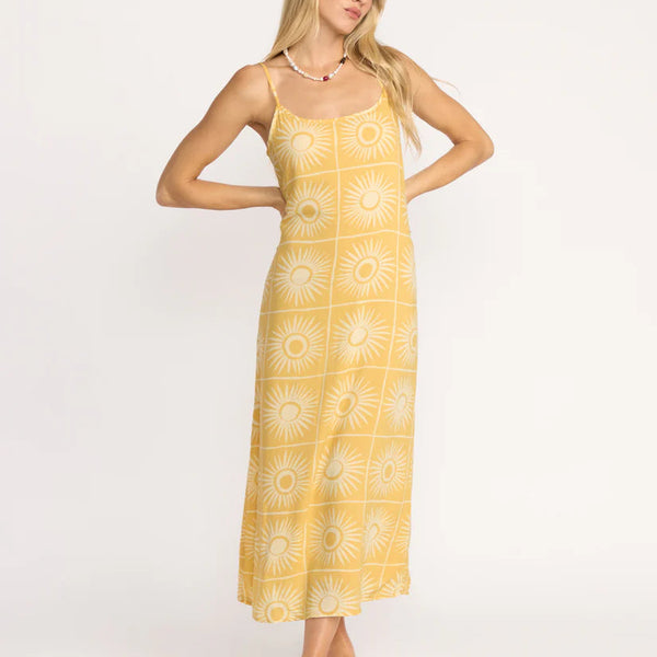 Woman wearing a yellow patterned dress on a white background