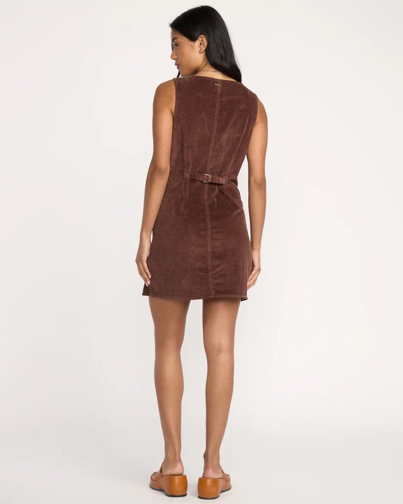 Woman wearing a brown suede dress on a white background