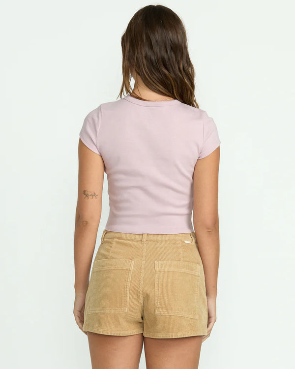 back view of the model wearing the tropical mindset tee. shows the slim fit. also shows the short sleeves, the light purple color and the crew neckline. 