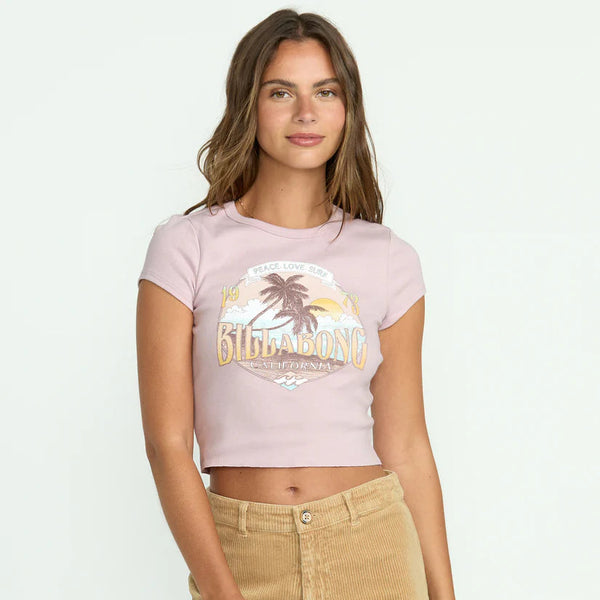 front view of the model wearing the tropical mindset tee. shows the crew neckline. also shows the screen print on the front, the cropped length and the light purple color. 
