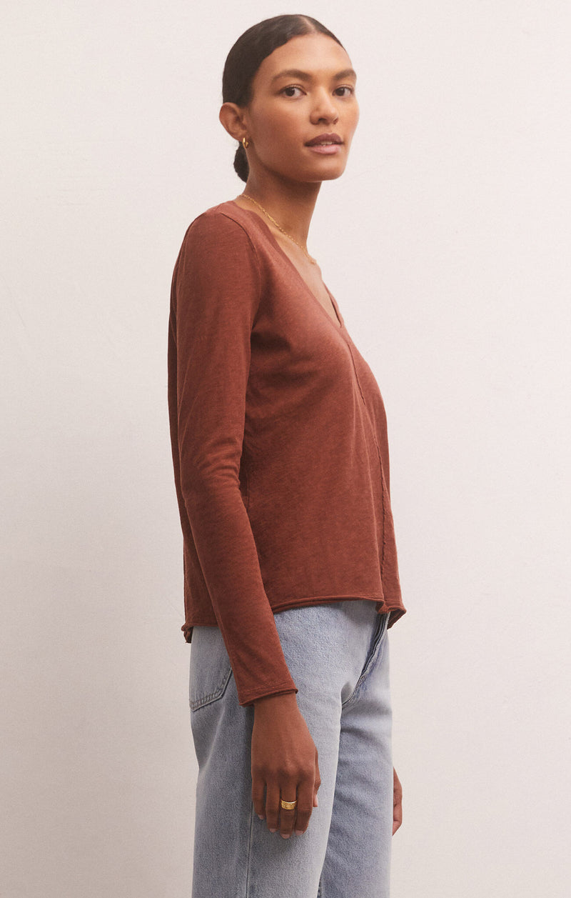 shows side view of model in rosewood top. shows the semi cropped length and long sleeves.