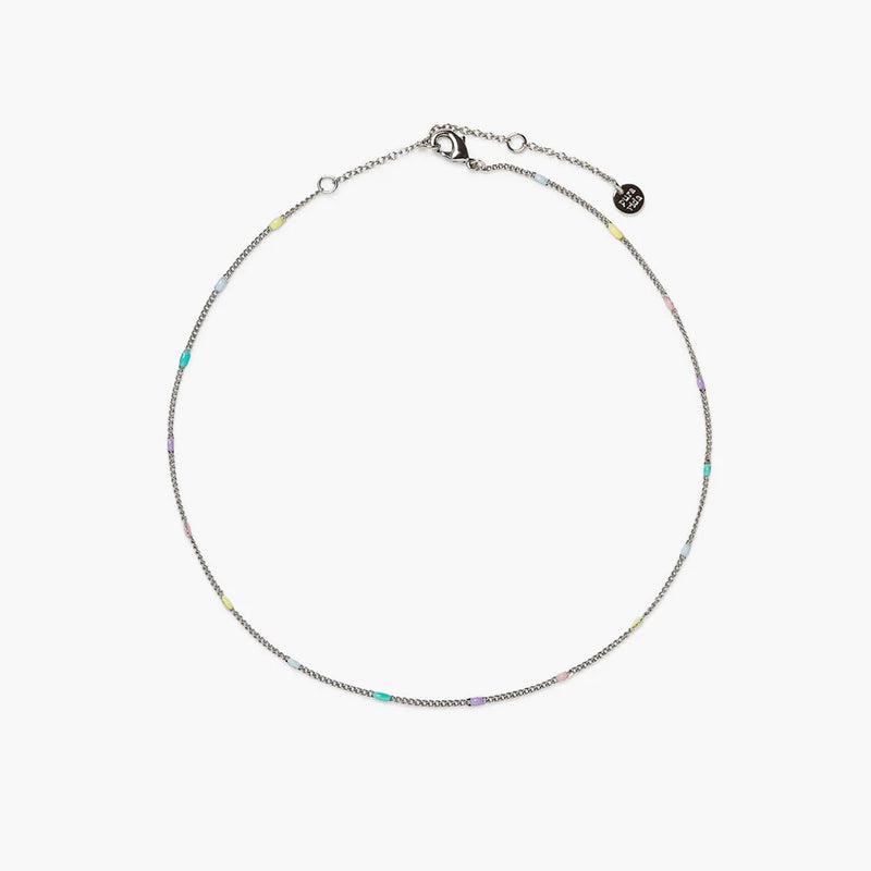 Shows a white backdrop with a silver chain anklet lined with light blue, teal, purple, pink, and yellow beads. features a lobster closure, 2 extensions, and a round charm etched with "pura vida" on the end.