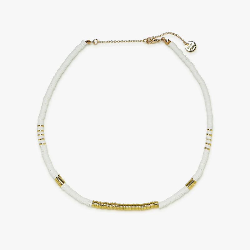 Shows choker with flat white and gold beads. Shows adjustable chain clasp. 