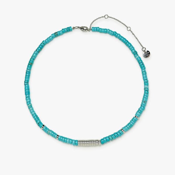 Choker is laying on a flat surface which shows blue and silver flat beads and the adjustable chain and clasp.