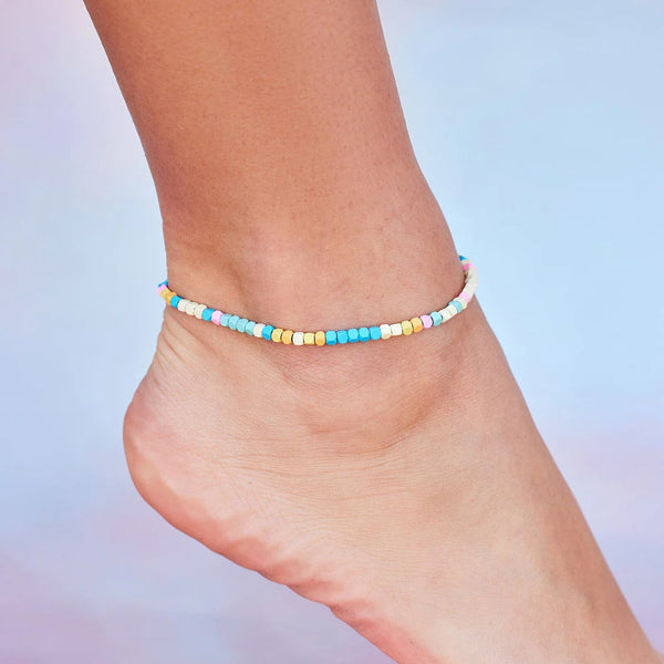 Another photo of multi colored hematite bead anklet on models ankle.