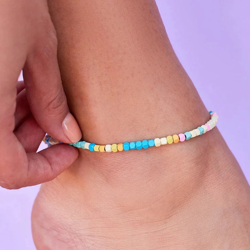 Multi colored hematite bead anklet is on models ankle.