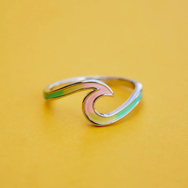 Shows ring on flat surface. Showcases multi color enamel on wave.