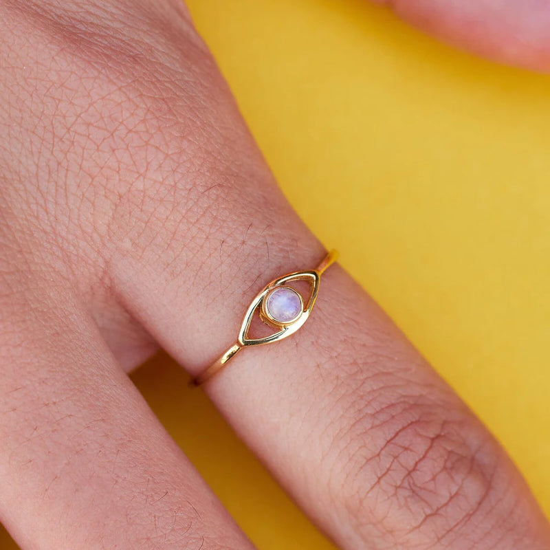 Shows gold ring on models finger. Has an eye with a rainbow moonstone in center.- Natural stones: 3mm diameter - Protective eye: 6mm (W) x 3.5mm (H)