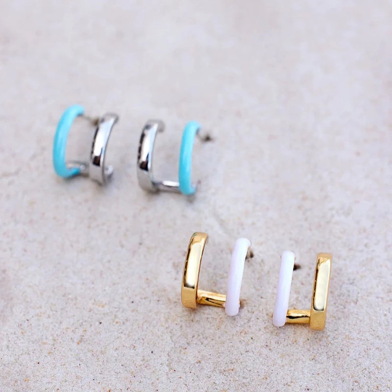 Both the silver and gold colorways are shown. Double hoop illusion. One solid gold or silver paired with an enamel color.